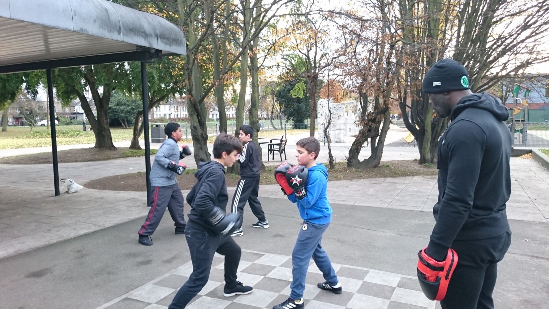 MEM coach leading a non-contact boxing session with young people in a London park.